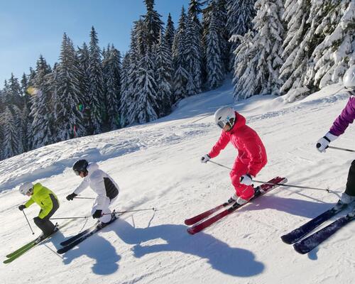 A group  of skiers on a ski slope