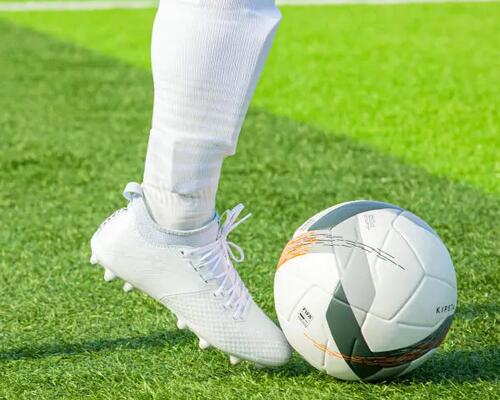 Man dribbling with shinpads on