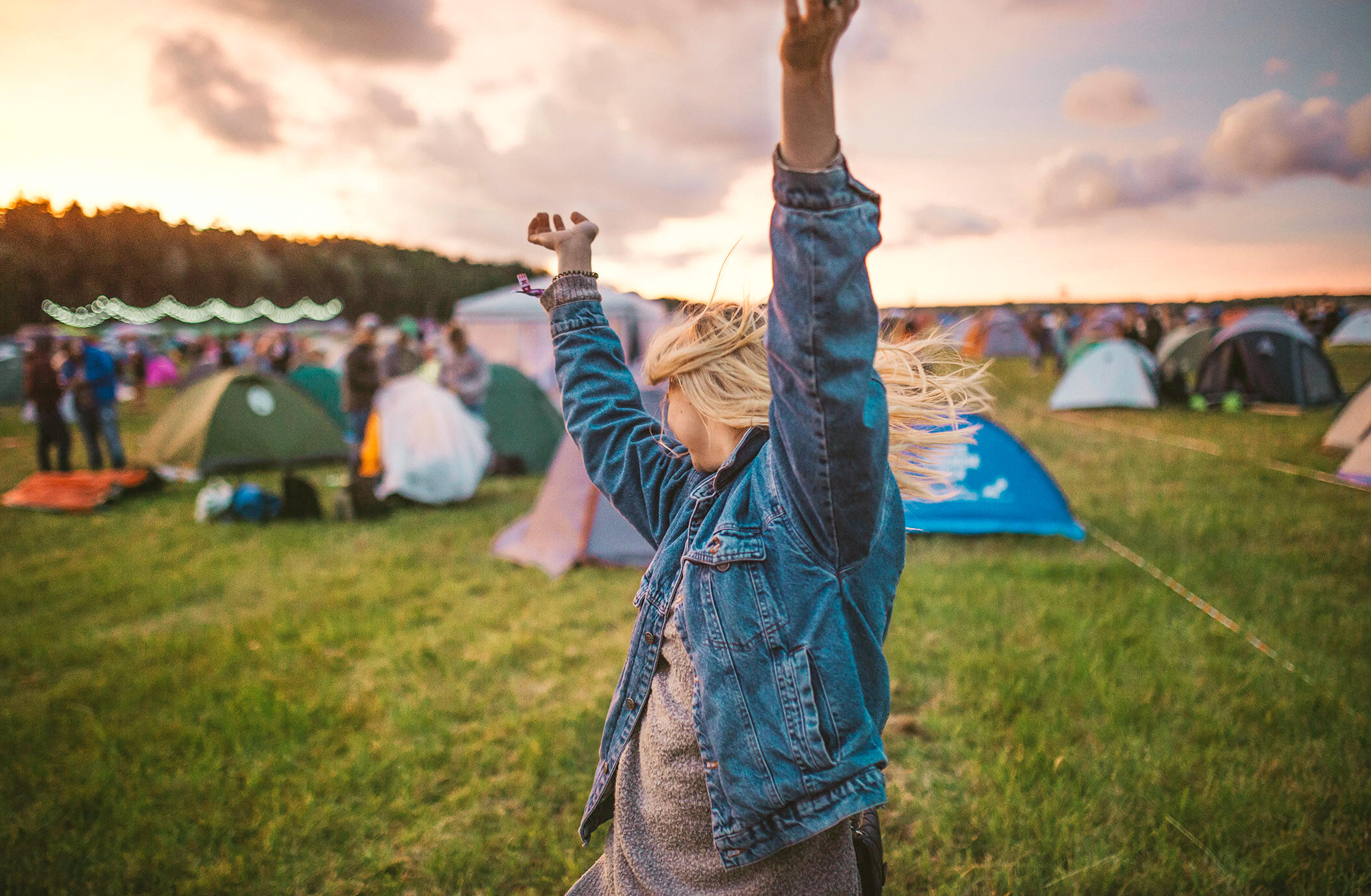 a group of friends around festival campsite 