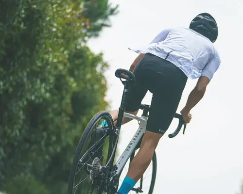 Women posing bib shorts on a green background
