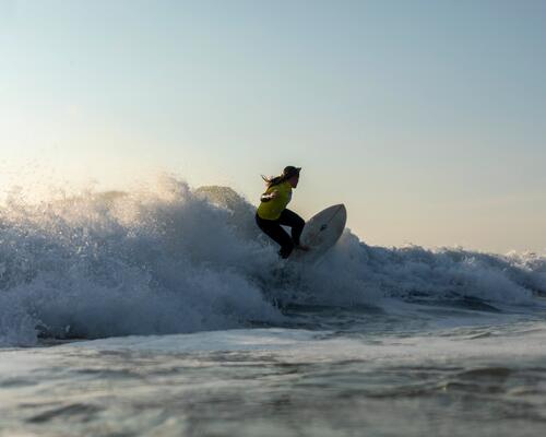 Woman riding wild wave.