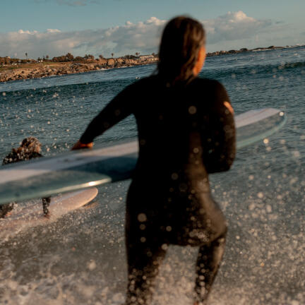 A woman with a surfboard