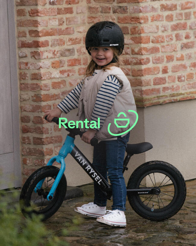 Girl standing with a Van Rysel kids bike