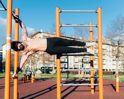 Mężczyzna udoskanalający figure human flag na drabince