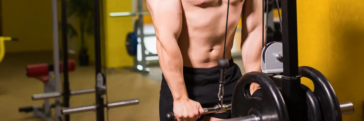 Mężczyzna ćwiczący triceps na wyciągu