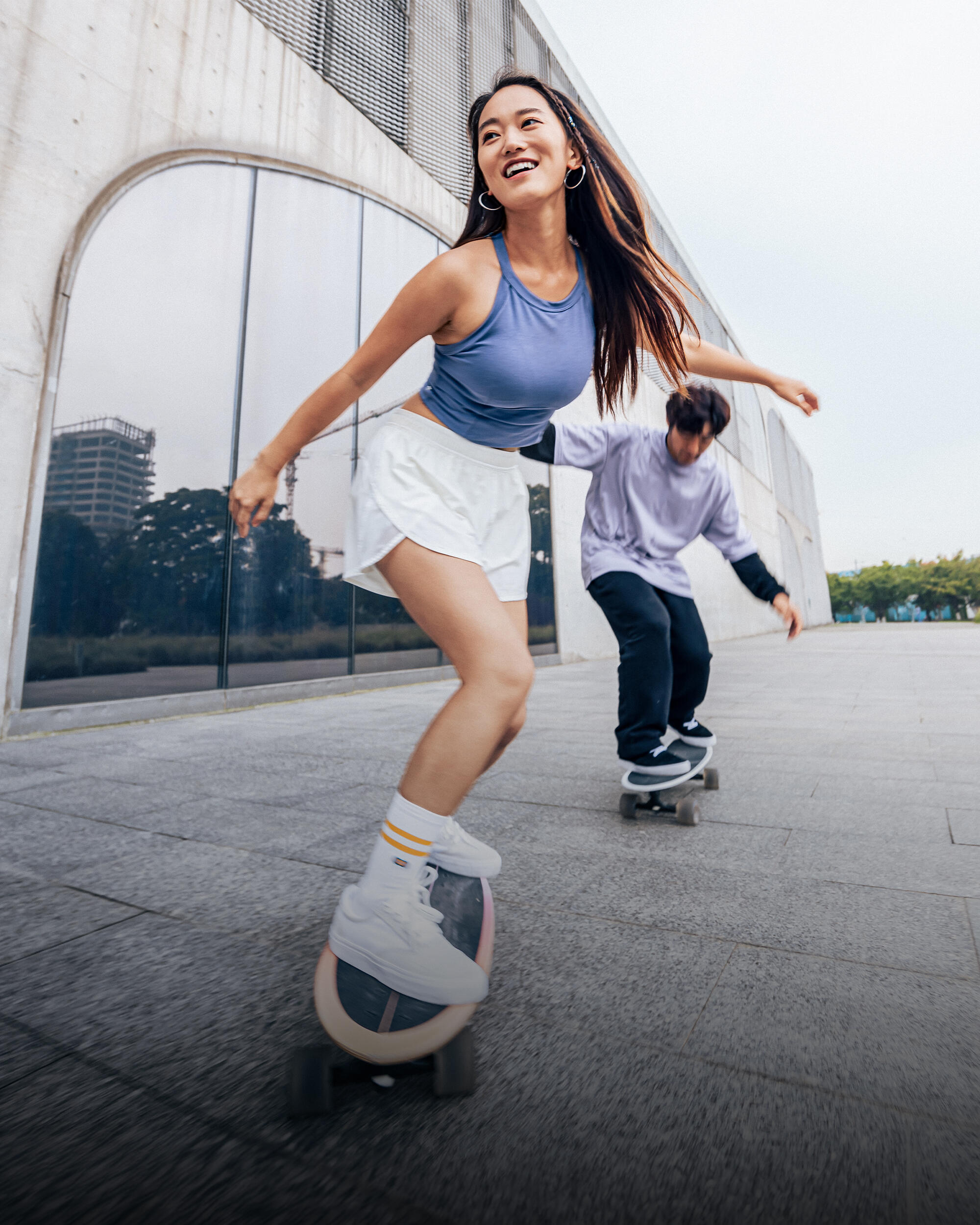 Man and lady skateboarding
