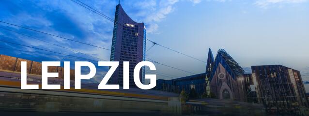Ein weißer Schriftzug mit Leipzig im Vordergrund.