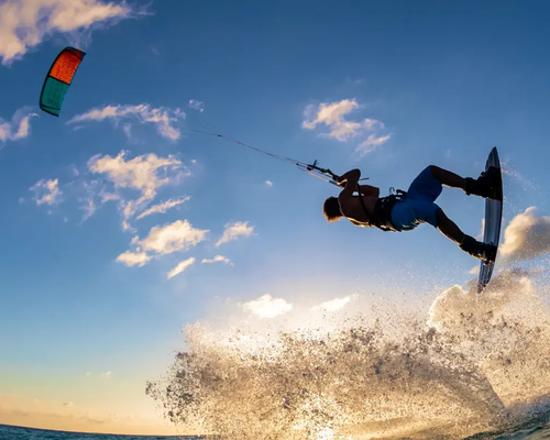 Mężczyzna próbujący wykonać kiteloop trenując kitesurfing