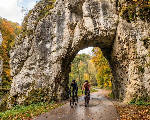 Rowerzyści w kaskach jadący rowerem przez Ojcowski Park Narodowy