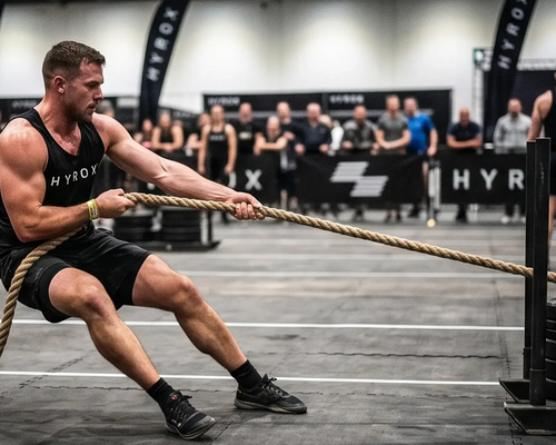 Mężczyzna ciągnący sanie sled pull podczas Hyrox