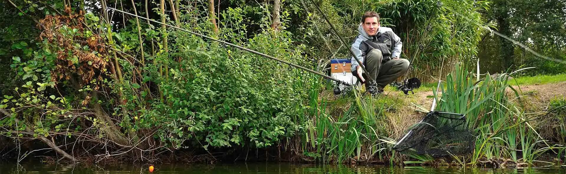 Man fishing for trout in greenery 