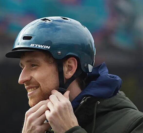 A man happily putting on his cycling helmet.