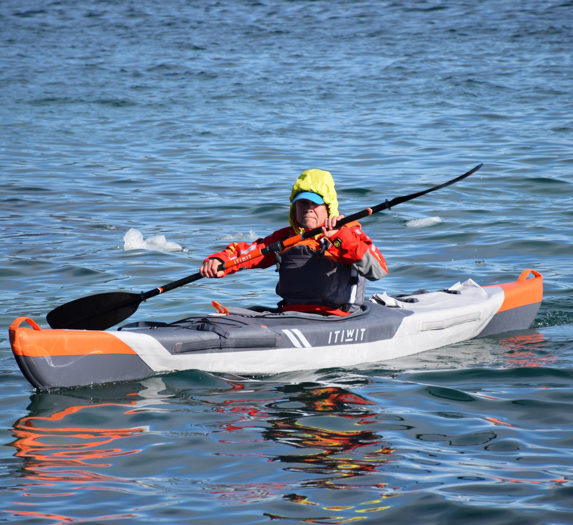someone cold water kayaking with warn clothes on 