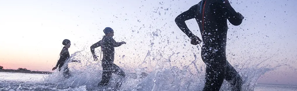 People running into water