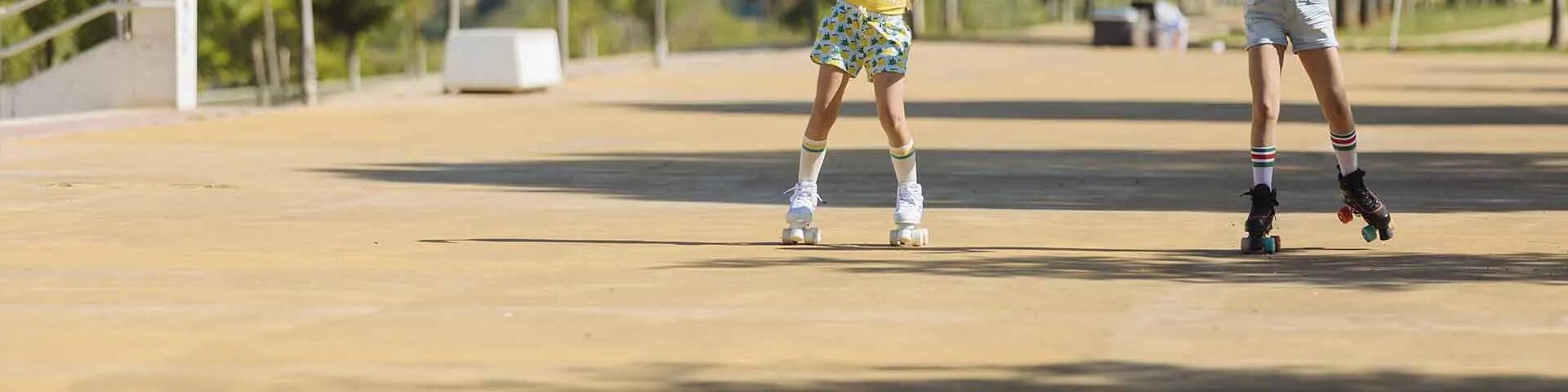 Two children roller skating outdoors