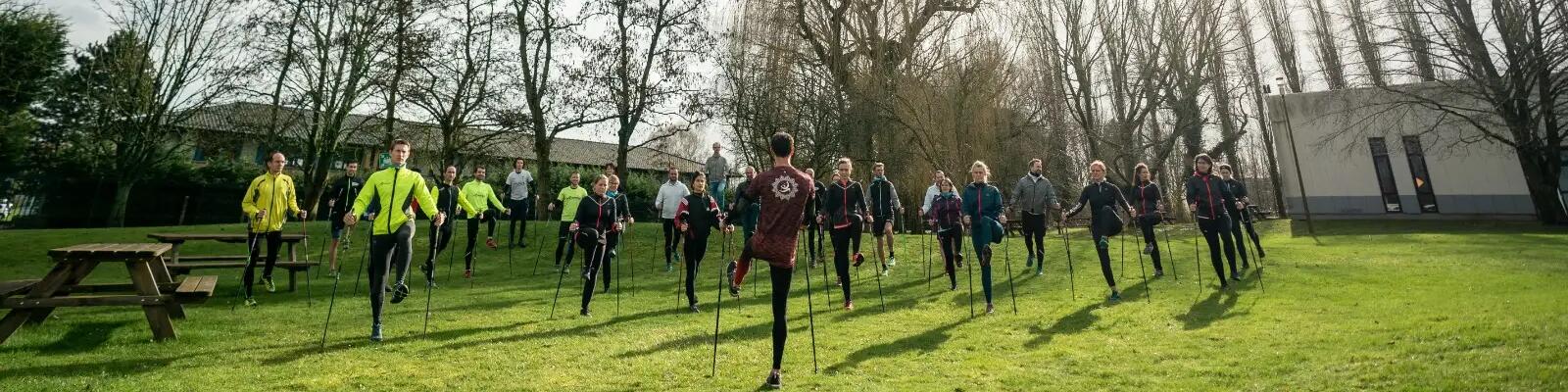 ludzie rozgrzewający się przed treningiem w strojach sportowych