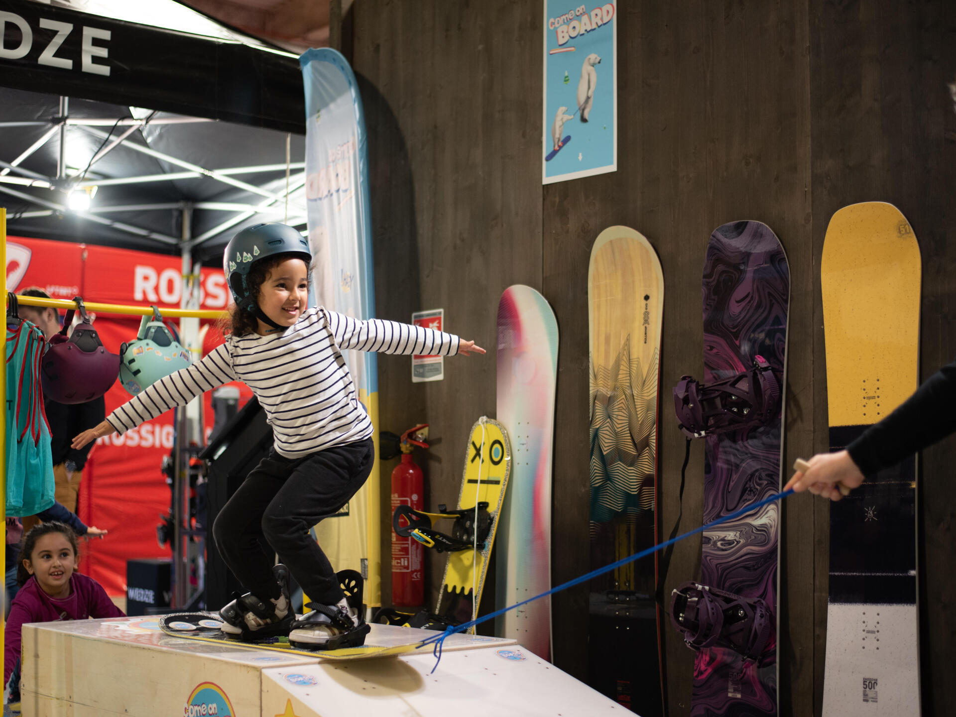 At what age can a child take their first snowboard lesson?
