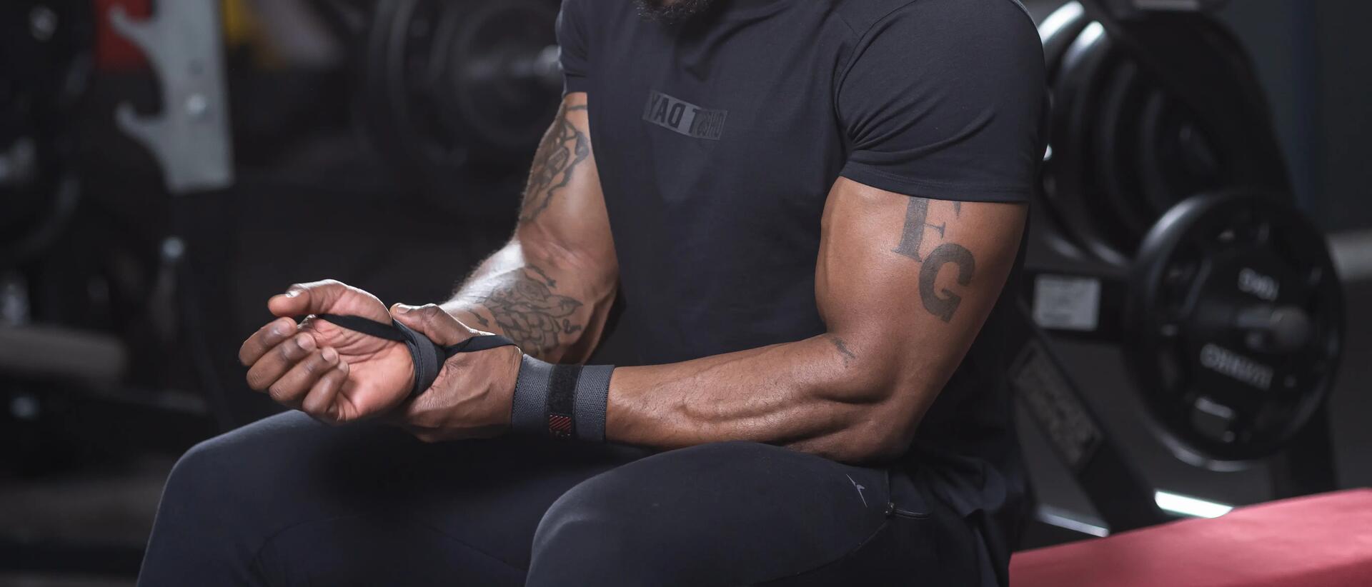 Man wrapping wrist in gym