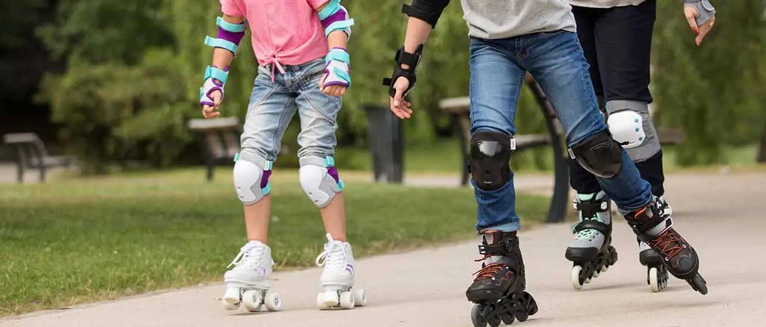 Three people riding roller skates in the park