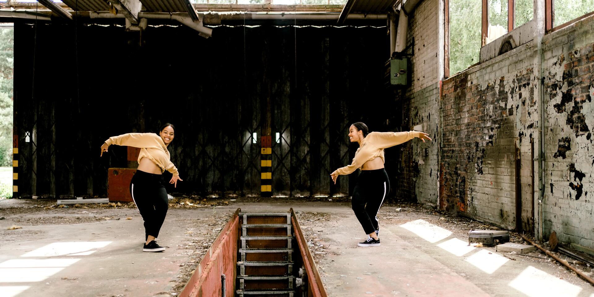 Two women dancing, facing each other