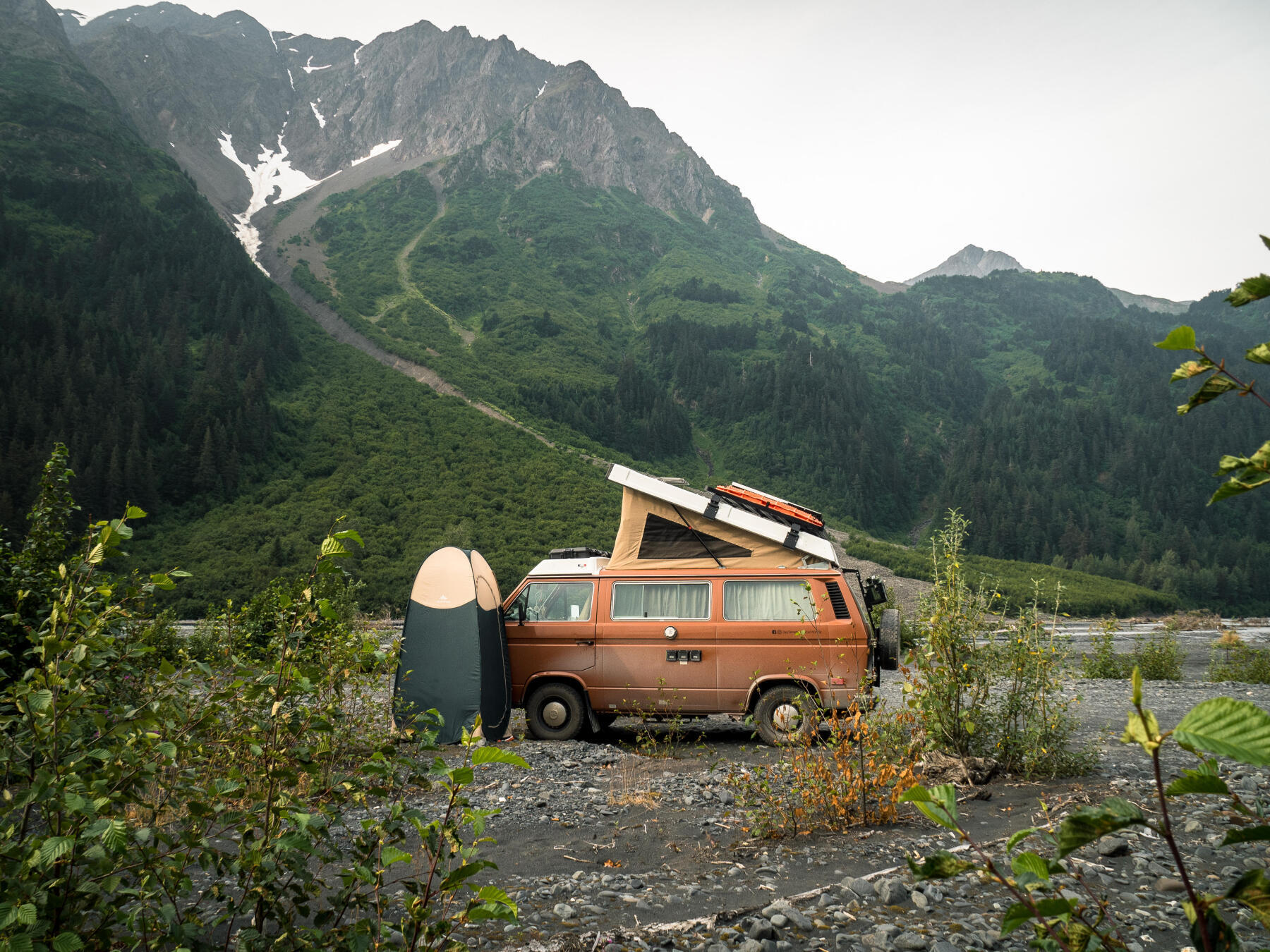 Van parked at the foot of a mountain in the Canadian Rockies