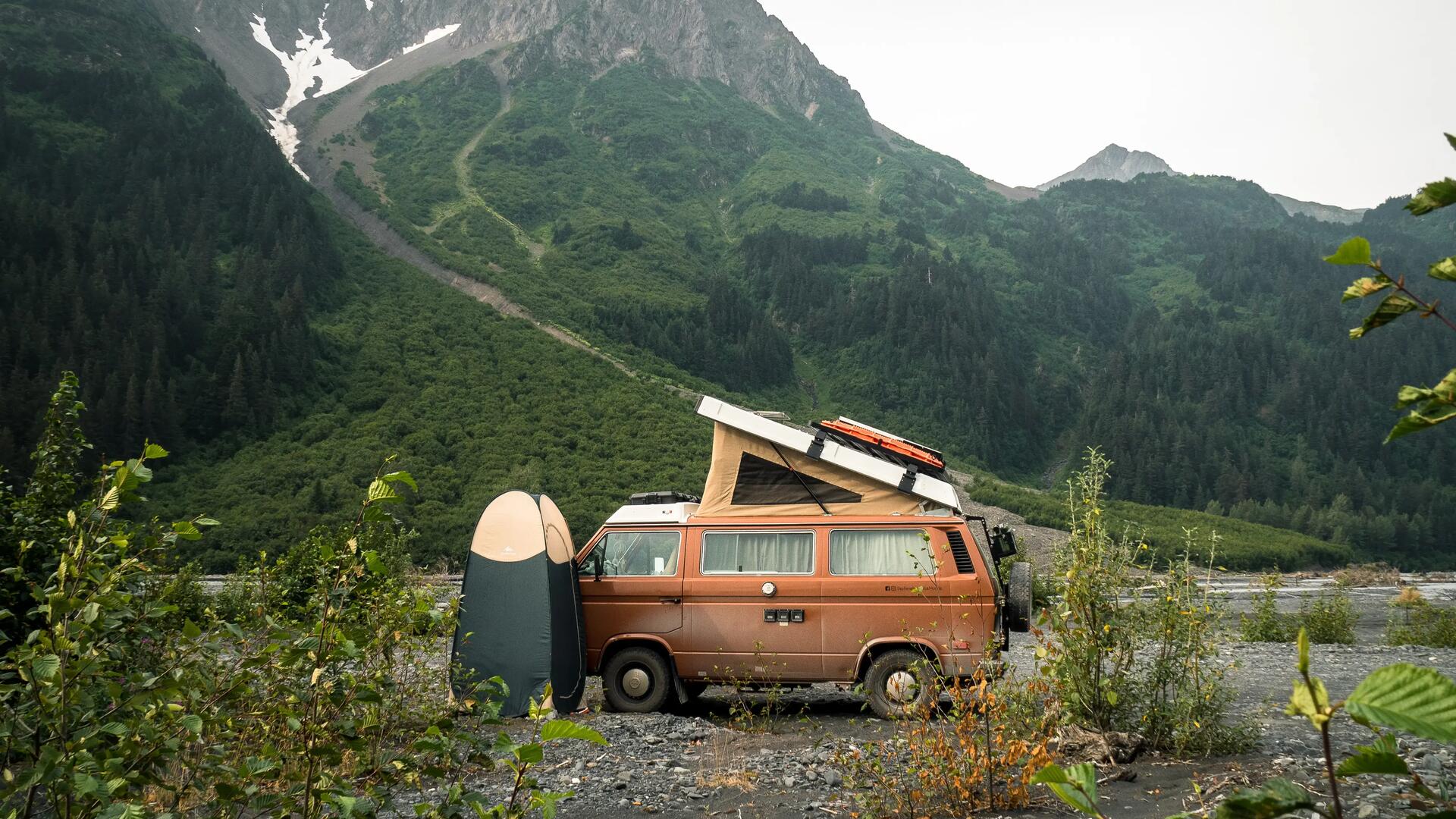 Van parked at the foot of a mountain in the Canadian Rockies