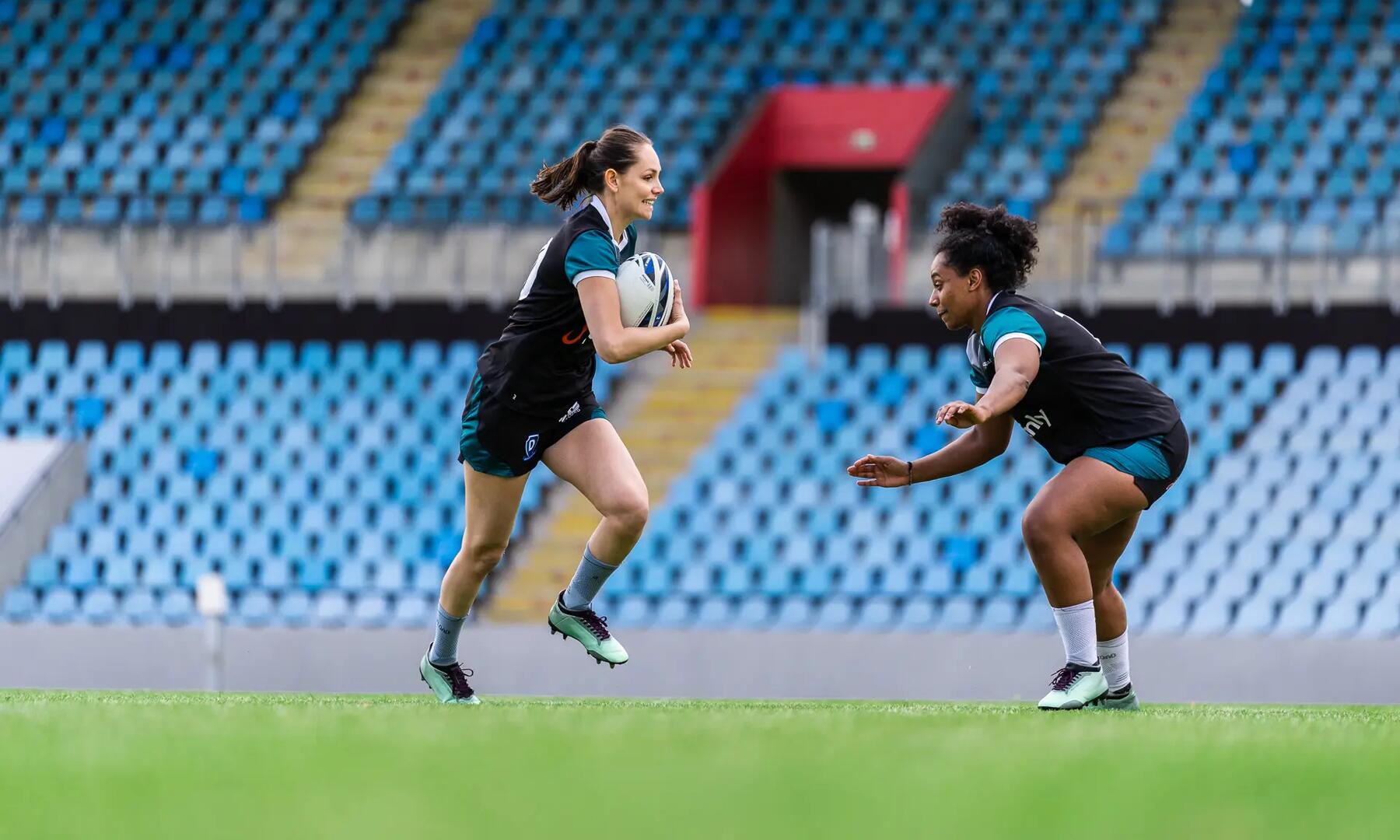 Two women playing rugby