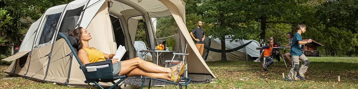 Kids playing outside of camping tent.