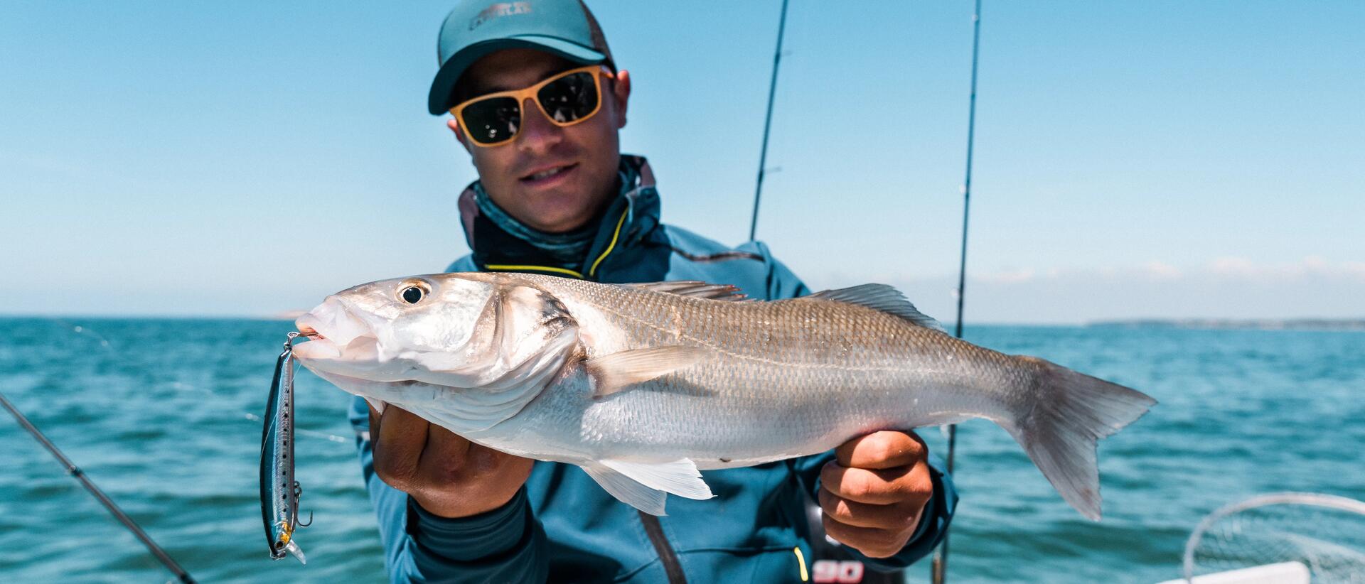 Man showing fish on boat