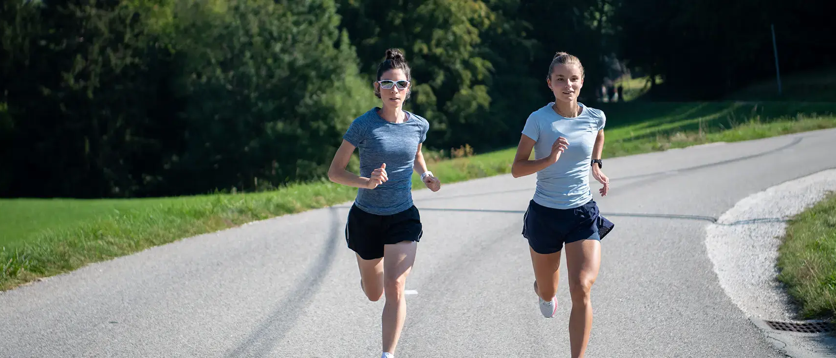 Two women running on road