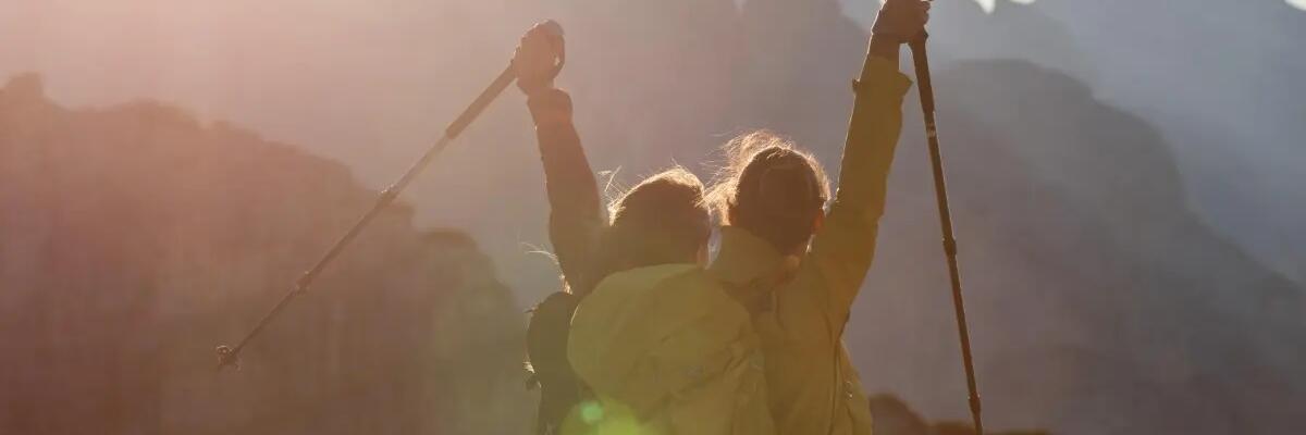 Two women hiking and holding nordic walking poles