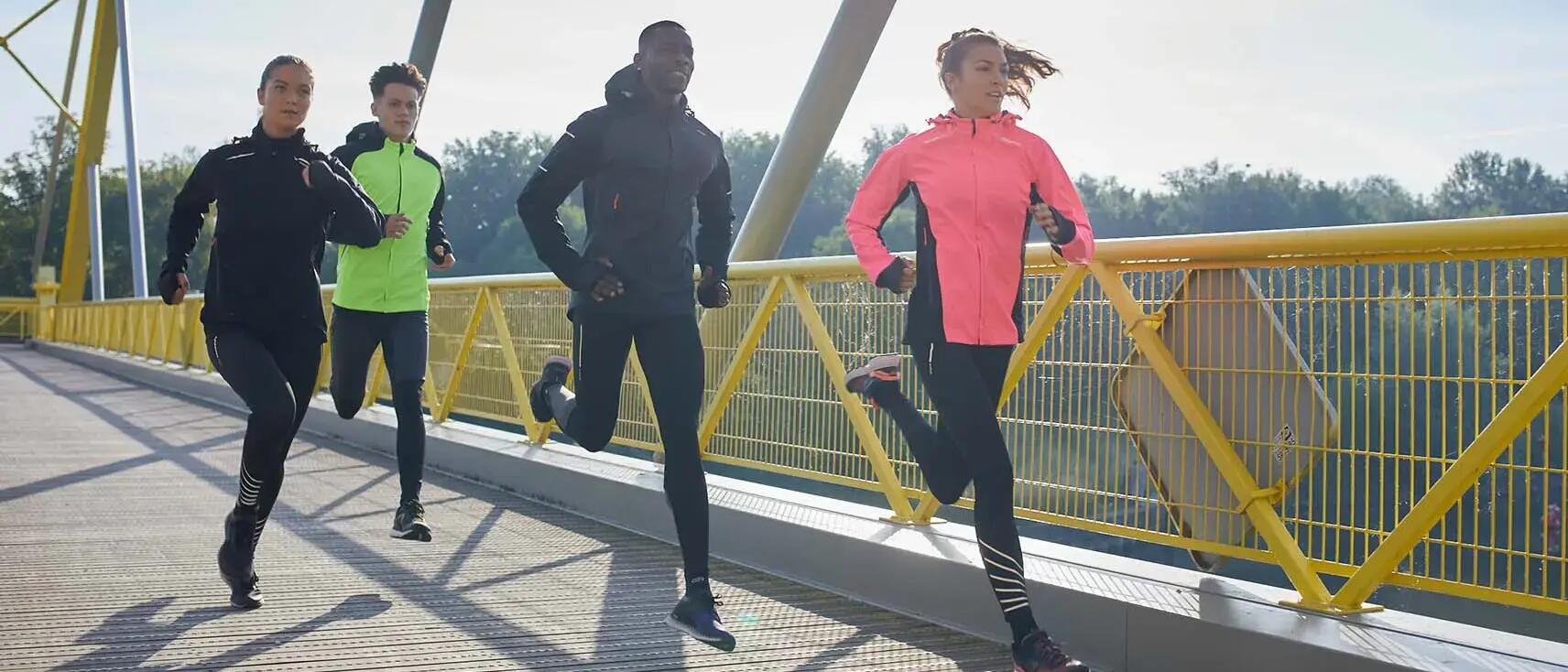 Group of people running together on bridge