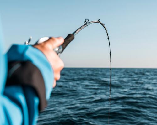 Man long casting in sea