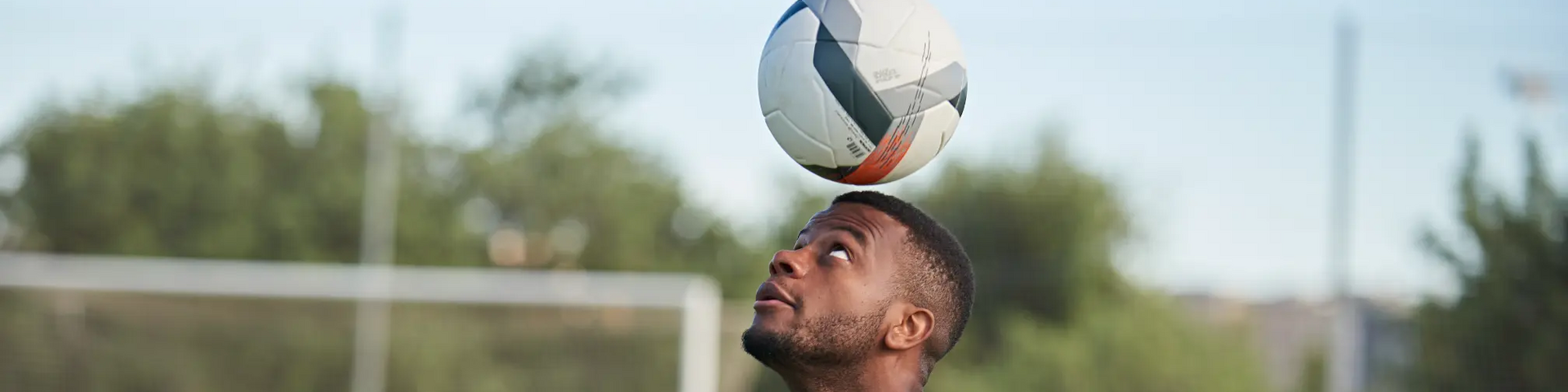 Man balancing football on his head