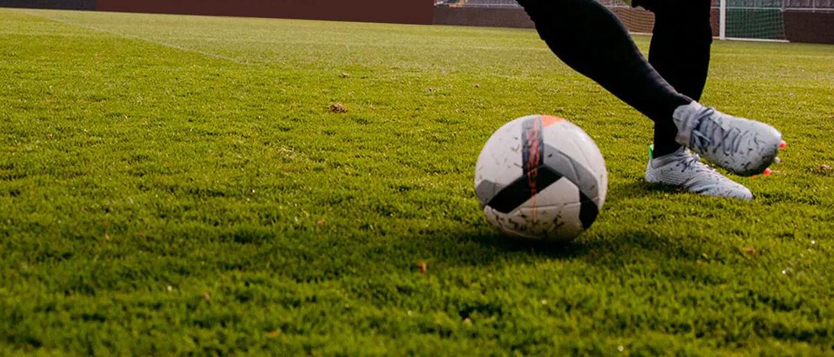 Close-up of man dribbling ball on golf pitch