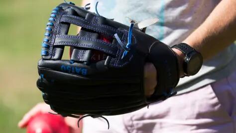 a close up of a baseball glove and ball