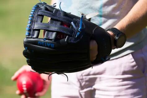 a close up of a baseball glove and ball