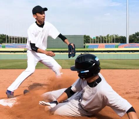 two men playing baseball one is running to the base