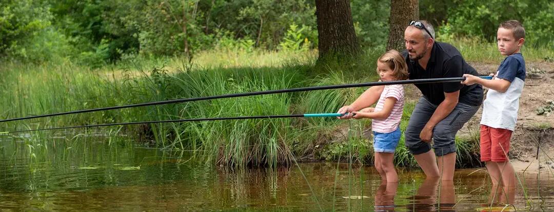 Father fishing with son and daughter