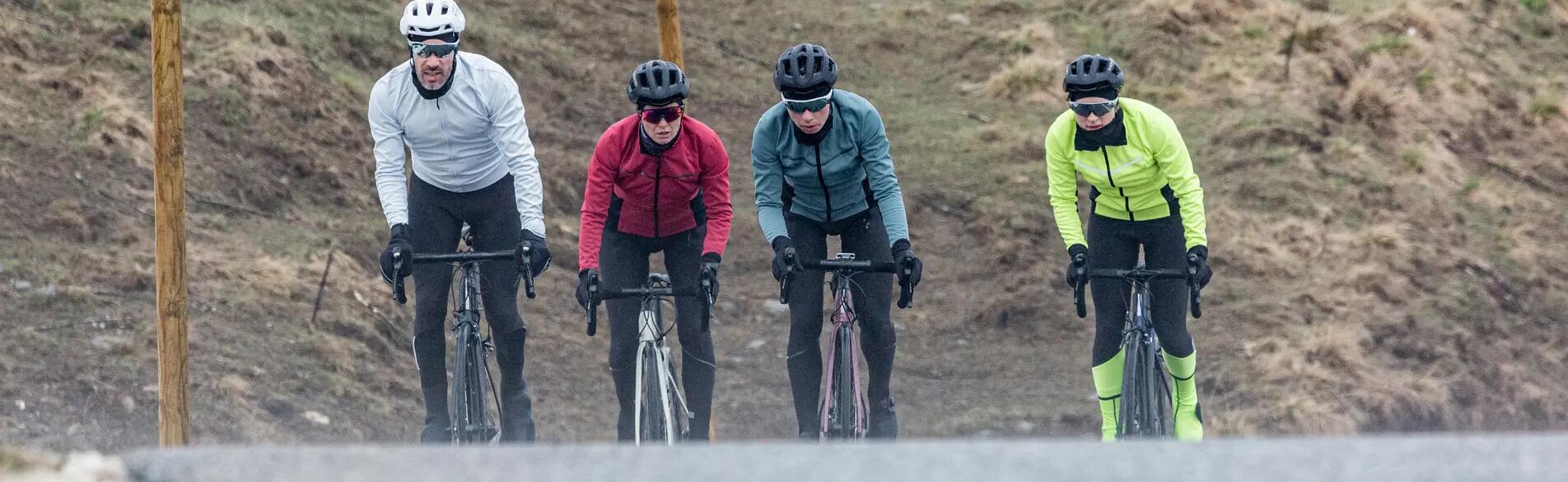 4 people cycling next to each other on the road