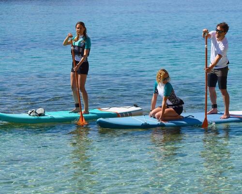 three people on Stand up paddle baords