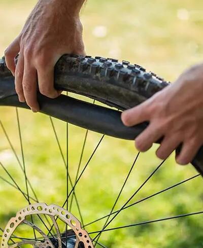 man repairing bike tyre