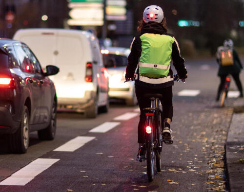 Cyclist commuting at night with high visibility vest