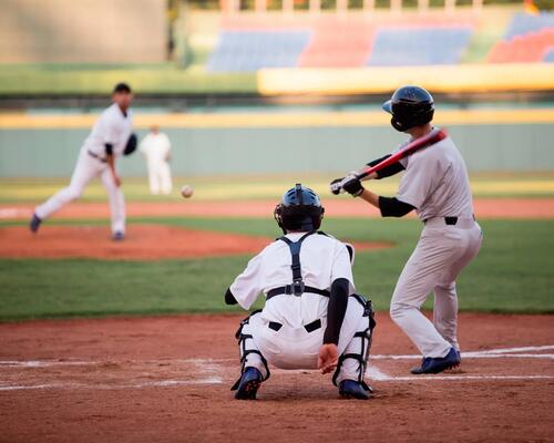 people playing baseball on a baseball field