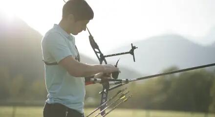 A man fitting his archery bow and arrow