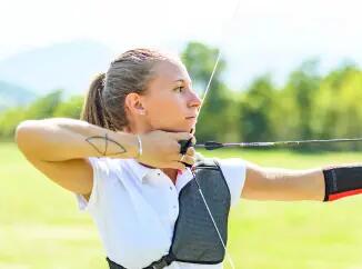 lady holding and aiming an archery bow and arrow 