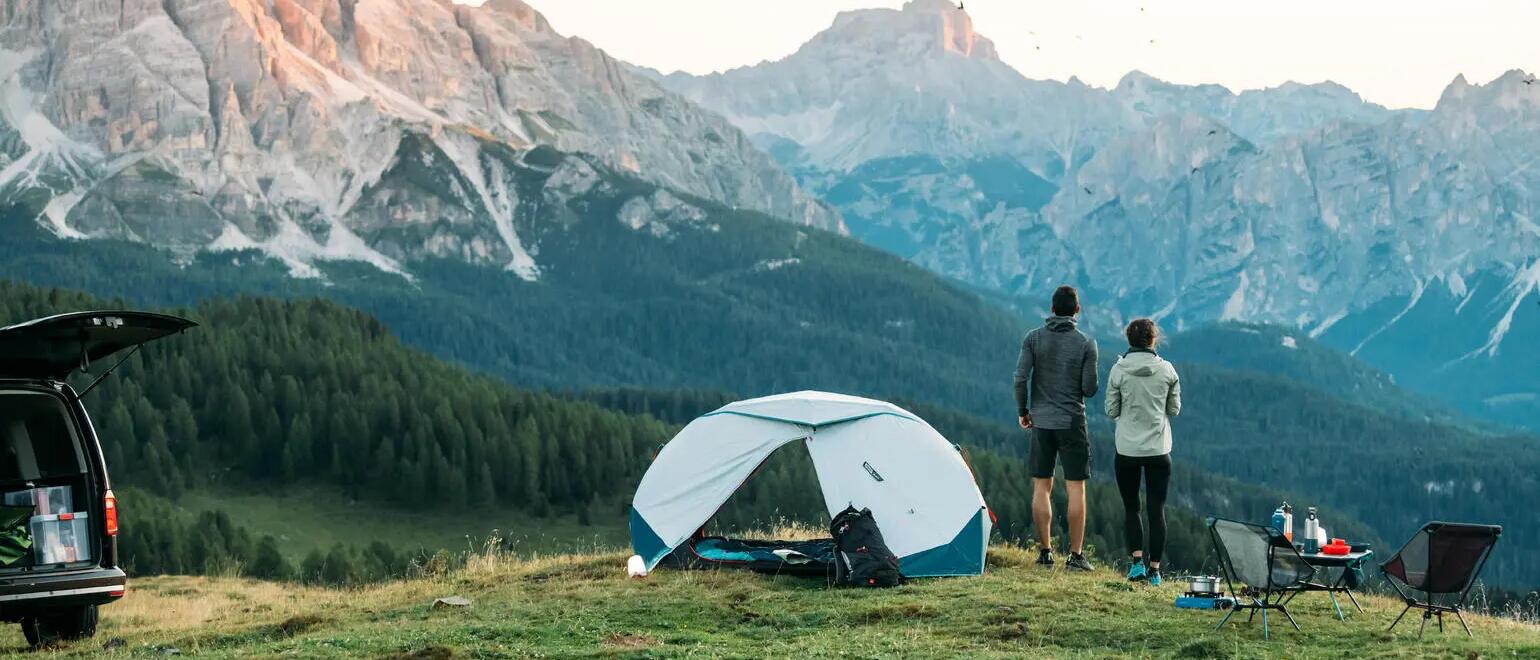 Man and woman looking at mountain sights during camping trip
