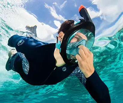 Man holding his nose while snorkeling
