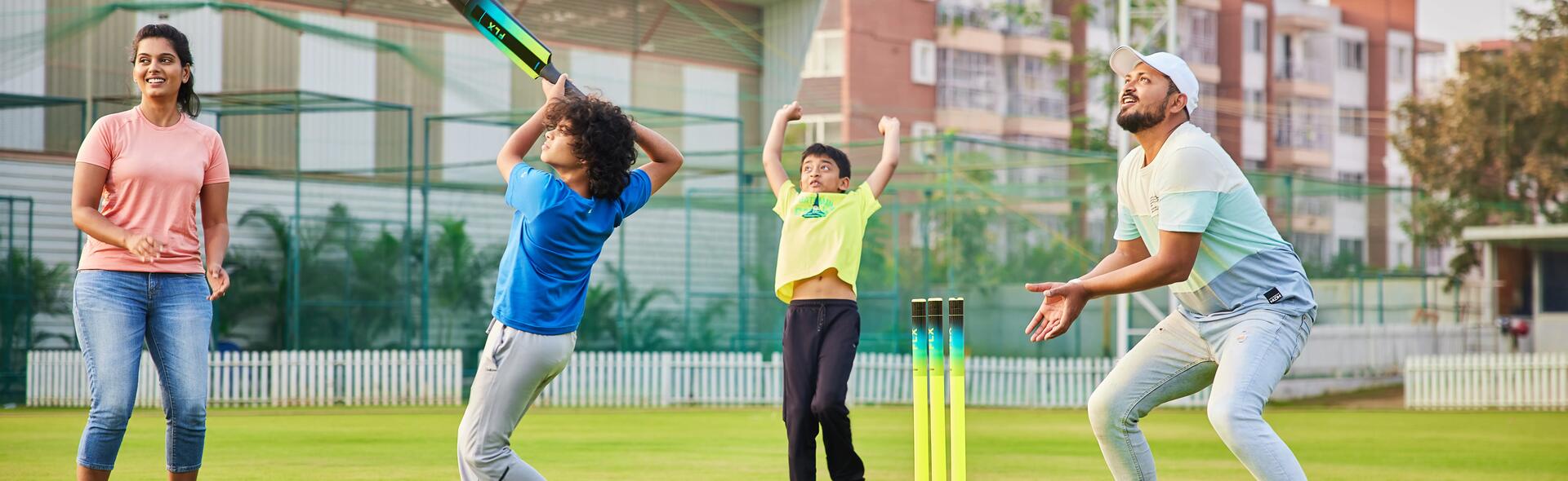 Family playing cricket outdoors