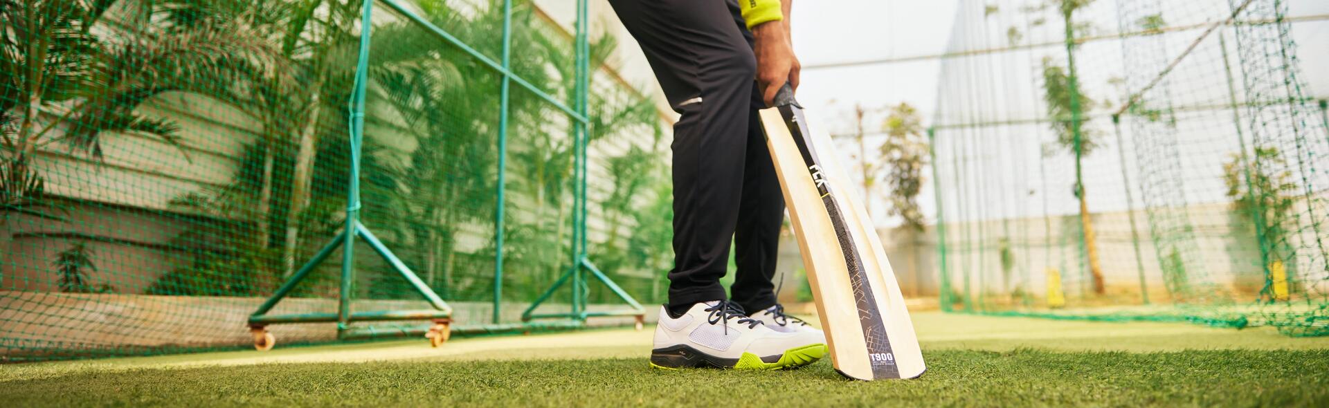 focus on man holding a cricket bat